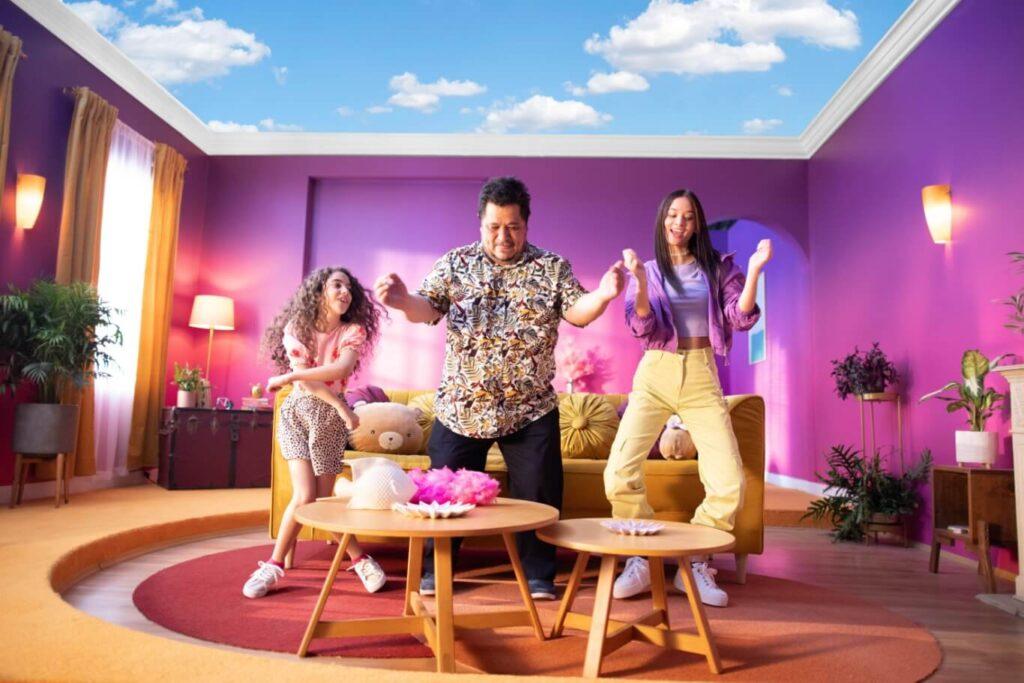 Father and daughters dancing in living room